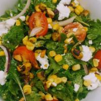 Kale Salad · Goat cheese, grilled corn, sweet onion, tomatoes, pistachios, roasted poblano vinaigrette.