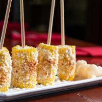 Mexican Style Corn On The Cob · Grilled corn lightly covered with mayo, queso fresco, and chili powder