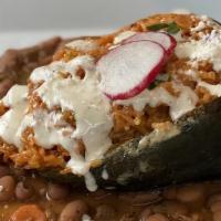 Chile Relleno · A large roasted poblano pepper filled with shrimp, rice, cheese, served on a bed of charro p...
