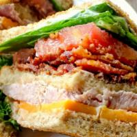 Cherry Market Signature Club · Roasted turkey, hand-carved ham, bacon, cheddar, romaine, tomato, onions, house dressing on ...