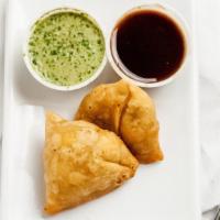 Vegetable Samosa · Pastry stuffed with potatoes and green peas. Served with tamarind sauce.