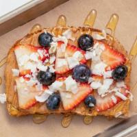 Almond Berry Toast · Almond butter topped with strawberries, blueberries, coconut flakes and agave, on organic mu...