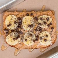 Peanut Butter Toast · Topped with sliced bananas, vegan chocolate chips, chia seeds and agave, on organic multi-gr...