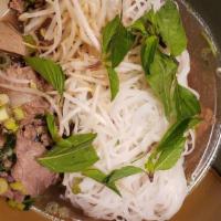 Combo Pho · Beef rice noodle soup topped with scallions served with vegetable garnish and choice or any ...