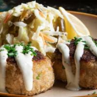 Blue Crab Cakes · Louisiana blue crab meat, onions & peppers, pan-seared, creole coleslaw, cilantro-lime mayo.