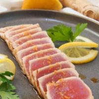Tuna Tataki · Slice seared pepper tuna on top of slice cucumber with masago, scallion and ponzu sauce.
