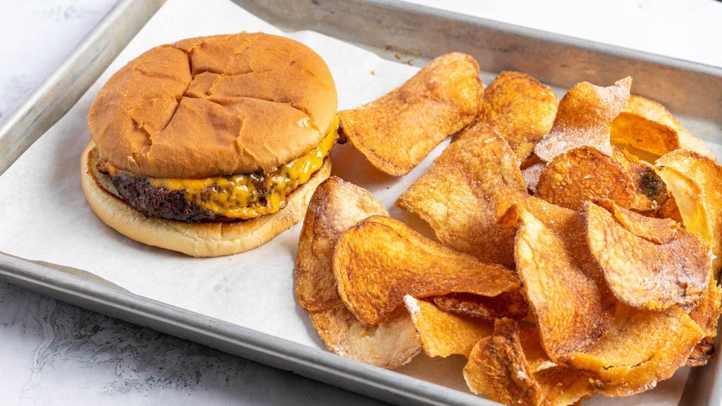 Kid'S Cheeseburger · An Angus burger patty with melted cheddar cheese. Served with our house salt & vinegar chips & a hush puppy.