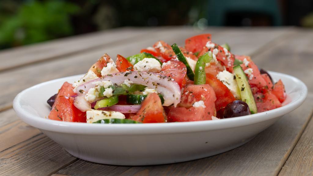 Small Greek Village Salad (Serves 1-2) · Horiatiki Salata - Tomatoes, cucumbers, green peppers, red onions, Kalamata olives, and Arachova feta cheese, sea salt, Vrisi36 EVOO.
 
*Village Favorite