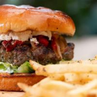 Lamb Burger · Hand-pattied and topped with feta, caramelized peppers & onions, lettuce, and tzatziki on a ...