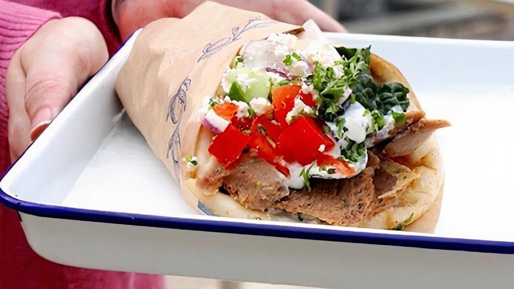 Gyro Wrap · Traditional gyro meat, lettuce, red onion, tomato, feta cheese, tzatziki, greek pita bread.