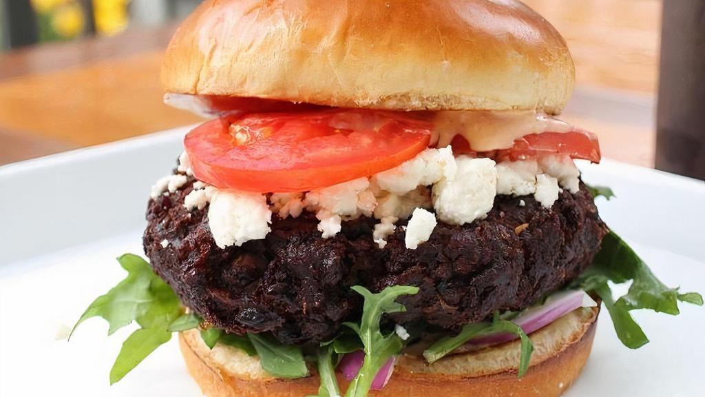 Veggie Burger · black bean patty, lettuce, tomato, red onion, feta cheese, spicy feta dressing.. *The black bean patty does have bread crumbs mixed into patty.