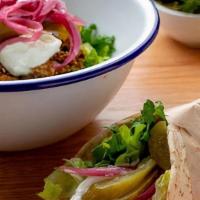 Chicken Shawarma Wrap · Romaine, Baby Kale, Tomato, Pickle, Pickled Red Onion, Garlic Sauce (Toum), Arabic Bread