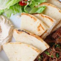 Braised Lamb Plate · Served with brown rice, mini greek salad, hummus and pita.