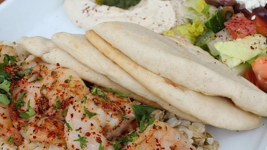 Grilled Shrimp Plate · Served with brown rice, mini greek salad, hummus and pita.