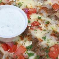 Traditional Gyro Pizza · Traditional gyro meat, red onions, tomatoes, house cheese blend, feta cheese. With a side of...