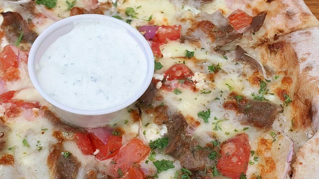 Traditional Gyro Pizza · Traditional gyro meat, red onions, tomatoes, house cheese blend, feta cheese. With a side of tzatziki.