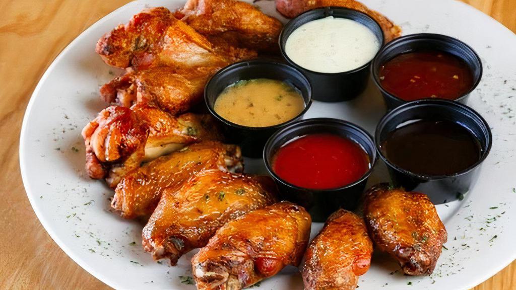 Italian Baked Chicken Wings · 8 Lightly Seasoned Wings Tossed with Italian Dressing. Served with Your Choice of Dipping Sauce. Buffalo, Garlic Parmesan, BBQ, Sriracha, Mango Habanero, Golden Glaze, Sweet Teriyaki, Roasted Garlic BBQ, Sweet Red Chile  or have them plain. Served with Ranch or Blue Cheese.
