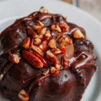 Caramel Turtle Chocolate Cake · Moist and Fudgy Chocolate Cake Enrobed in Chocolate, Topped with Toasted Pecans and filled w...