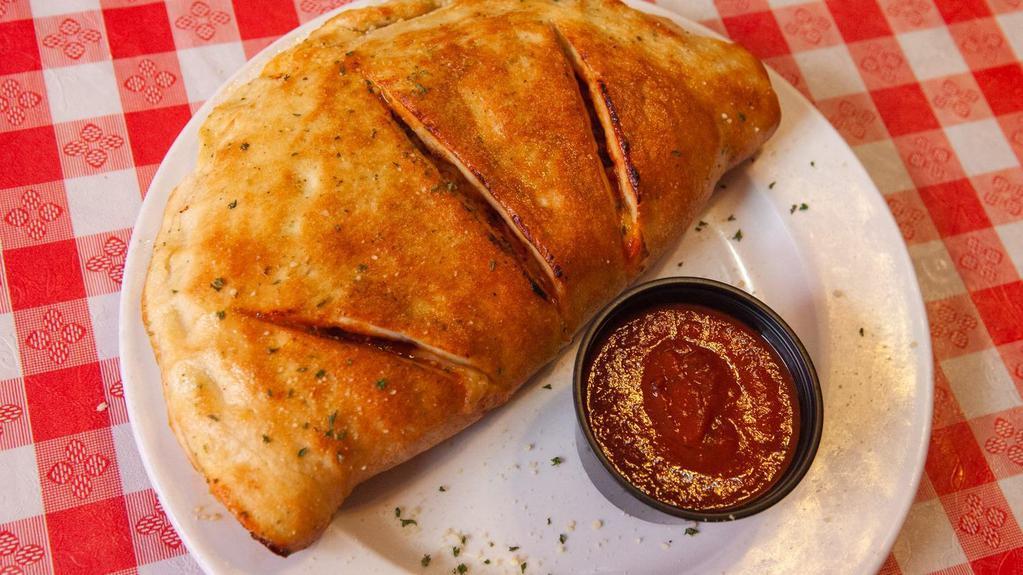 Italian Calzone (Large) · Our Classic, Pepperoni, Sautéed Onions, Green Peppers, Fresh Mushrooms, Italian Sausage, Ground Beef Topped with Marinara and Mozzarella Cheese.