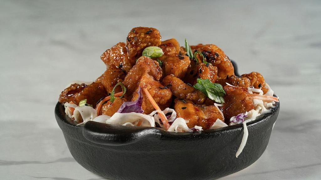 The Opener · Crispy flash fried pork belly tossed in our delicious Korean #2 sauce and served atop our freshly prepared creamy coleslaw.