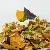 Macho Nachos (Half Portion) · Tortilla chips topped with queso, lettuce, tomatoes, and sour cream.  Half Order (serves 2) ...