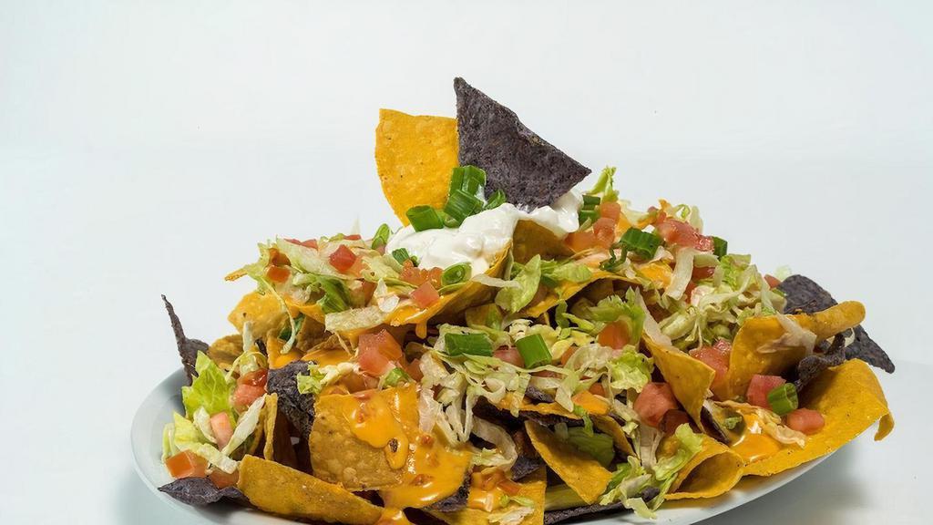Gf Macho Nachos (Half Portion) · Tortilla chips topped with queso, lettuce, tomatoes, and sour cream.  Half Order (serves 2).