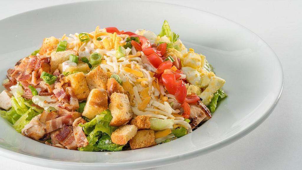 Gf Glory Days® Cobb Salad (Full Portion) · Chopped romaine hearts, grilled then chilled chicken breast, Bacon-Ranch dressing, hard-boiled eggs, diced tomatoes, bacon, grated Monterey Jack and cheddar, croutons, and green onions.