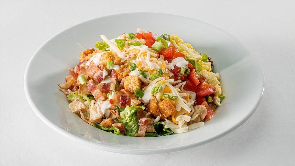 Glory Days® Cobb Salad (Half Portion) · Chopped romaine hearts, grilled then chilled chicken breast, Bacon-Ranch dressing, hard-boiled eggs, diced tomatoes, bacon, grated Monterey Jack and cheddar, croutons, and green onions.
