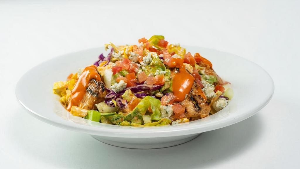 Buffalo Salad (Grilled Chicken) (Half Portion) · Grilled chicken, mild wing sauce, chopped romaine hearts, celery, tomatoes, carrots, cabbage, bleu cheese dressing, and bleu cheese crumbles.