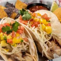 Grilled Fish Soft Tacos · Two soft flour tortillas with shaved cabbage, diced tomatoes, mango salsa, cilantro, and smo...