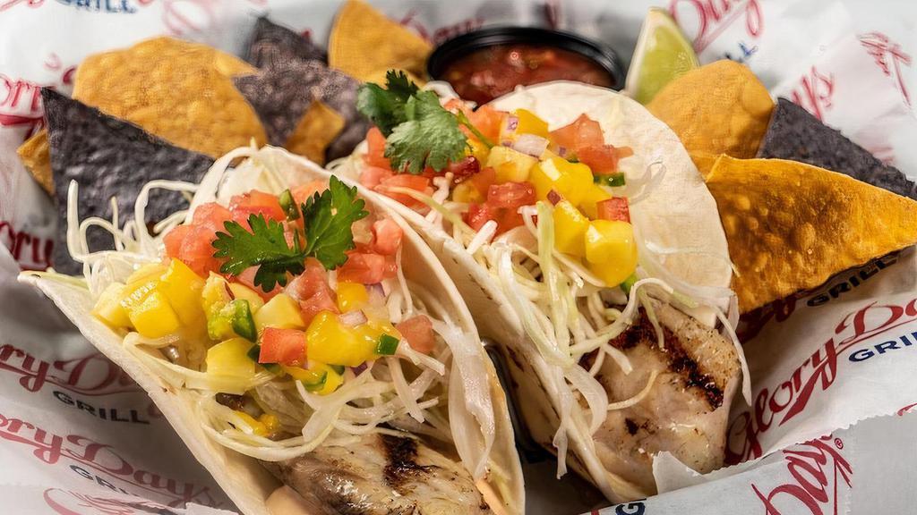 Grilled Fish Soft Tacos · Two soft flour tortillas with shaved cabbage, diced tomatoes, mango salsa, cilantro, and smoky-spicy chipotle mayo.  Served with chips and salsa.