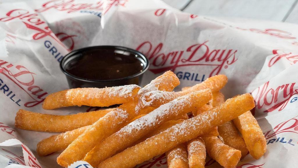 Funnel Cake Fries · Back by popular demand! Topped with powdered sugar and served with hot fudge for dipping.