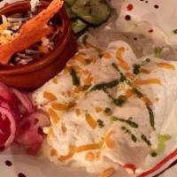 Lula'S Enchiladas · Corn tortillas filled with chicken, mixed veggies, and cheese with a tomato sour cream sauce...