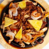 Lunch Fajita Tropical · Shrimp, chicken, chorizo, onions, red, and yellow bell peppers, and pineapple. Served with r...