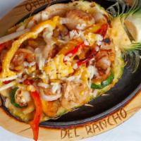 Piña Loca · Shrimp, scallops, chicken, zucchini, red, and yellow bell peppers, and onions all served in ...