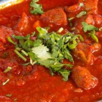 Lamb Vindaloo · Lamb cooked in hot spices in a highly seasoned gravy of potatoes, tomatoes and chili pepper.