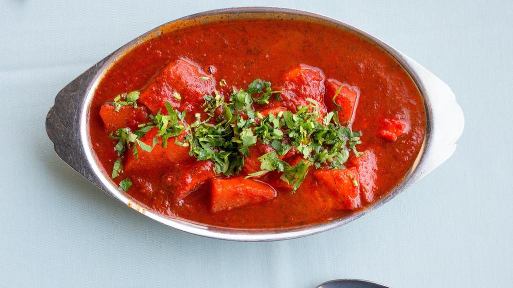Fish Vindaloo · Fish cooked in spices in a highly seasoned gravy of potatoes, tomatoes and chili pepper.