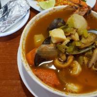 Caldo De Mariscos · Seafood soup. A large bowl of soup prepared with shrimp, fish, crab meat, crabs and vegetabl...