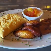 Taste Of The Tropics · Well-seasoned beef in a flaky shell and served with plantains and Caribbean mango and pineap...