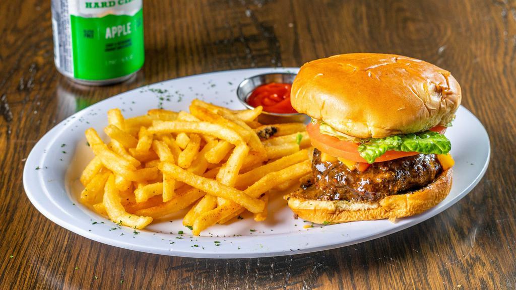 The Big Mon Jerk Burger · A mildly spicy burger, well seasoned with house made Jamaican jerk sauce.  Served with lettuce, onions, and tomatoes, served with your choice of side.