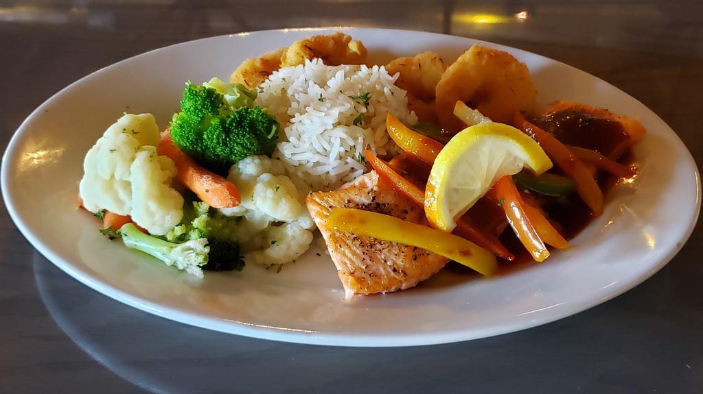 Surfin’ Seared Salmon · Salmon filet grilled and sautéed with veggies and served on bed of steamed Basmati  rice and 1 side