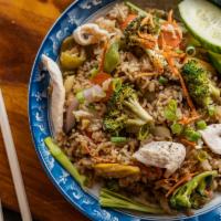 Chicken Thai Fried Rice · Stir fried rice, broccoli, onion, green onion topped with sliced cucumber, tomatoes, and a d...