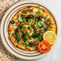 Za'Atar Deluxe Manakish · A blend of herbs and spices, cheese, tomatoes, olives, and mint on flatbread.