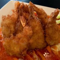 Bang Bang Shrimp  · Shrimps strips dipped in a light batter and lightly fried served over fresh mix veggies with...
