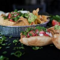 Nachos · Fresh corn chips, choice of beans, guacamole, sour cream, fresh salsa with melted jack and c...