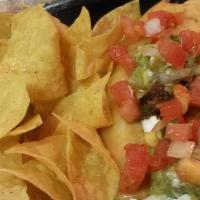 Bueno Burrito · Melted jack cheese, choice of protein, guacamole, and fresh pico de gallo salsa. Served with...