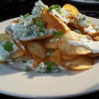 Blue Cheese Potato Chips · House made potato chips topped with bleu cheese crumbles, bleu cheese dressing and scallions.