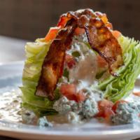 Bleu Cheese Wedge · Quarter wedge of iceberg lettuce with diced tomatoes, house made bleu cheese dressing, and D...
