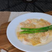 Lobster Ravioli · Lobster filled ravioli, tossed in sherry-lobster cream sauce. Accompanied by pan seared shri...
