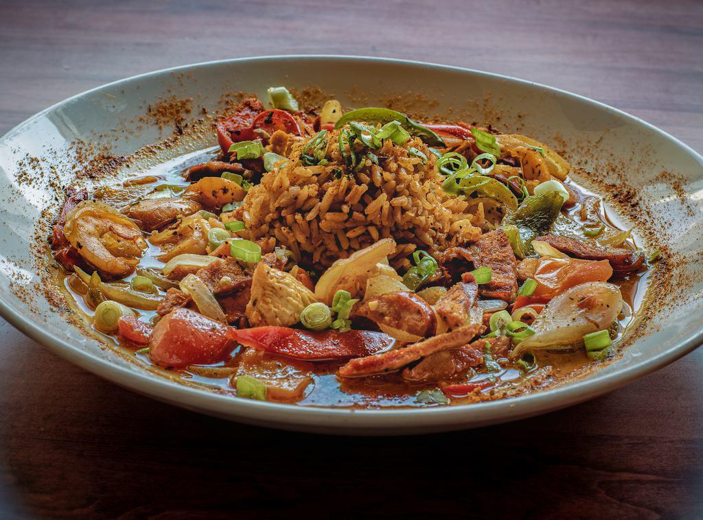 Jambalaya · Chicken, shrimp, and andouille sausage sauteed with onions, peppers, and cajun spices. Served with red rice and garnished with green onions and diced Roma tomatoes.